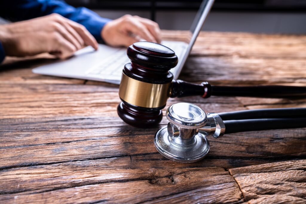 Gavel & stethoscope with hands